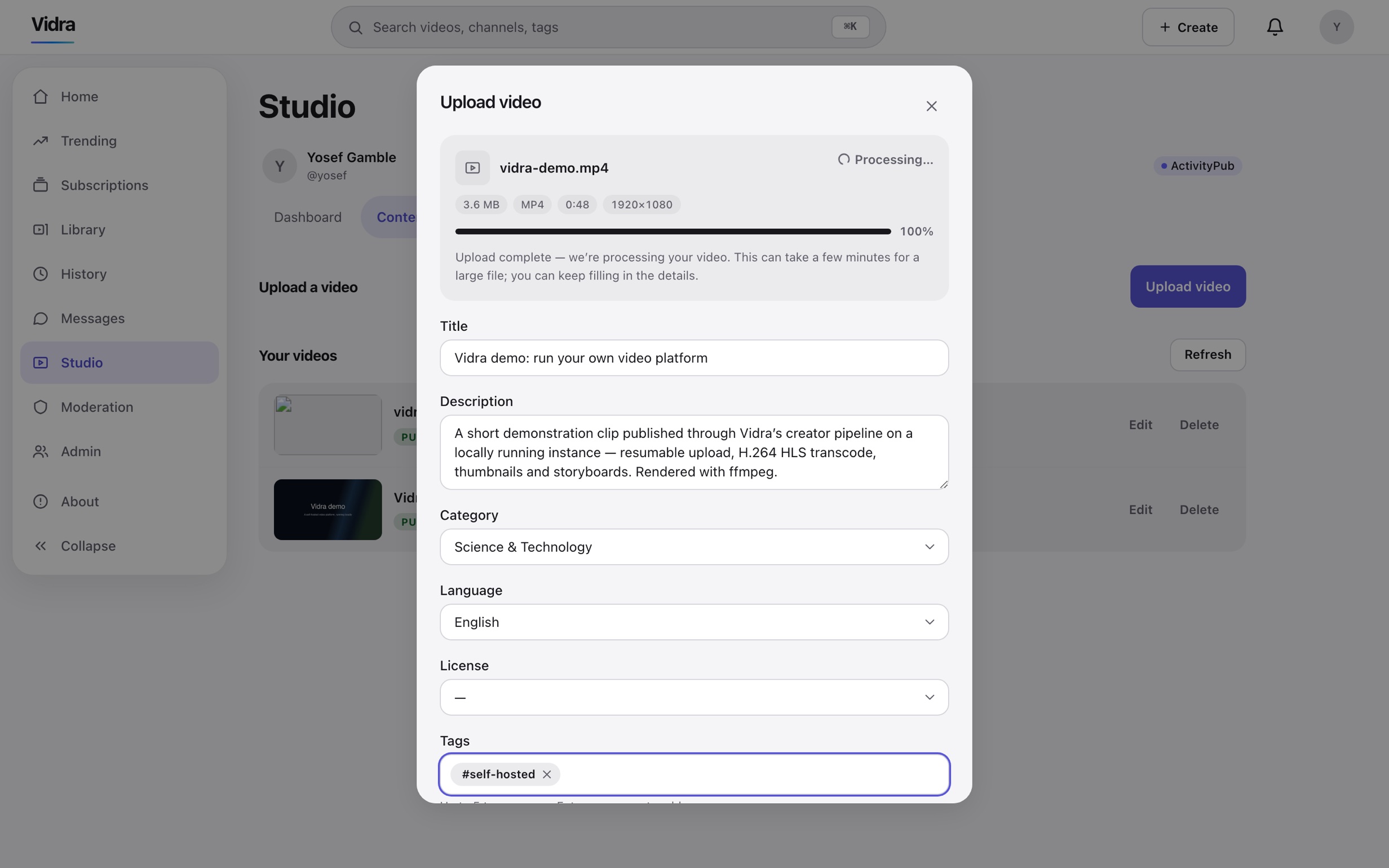 The studio upload sheet: vidra-demo.mp4 at 100 percent and processing, with title, description, category, language, license and tags fields filled in and an ActivityPub badge in the corner.